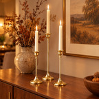 Gold taper candlesticks on a walnut dining sideboard in autumn