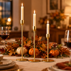 Gold taper candle holders as a Thanksgiving table centrepiece with pumpkins and autumn leaves