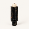 Eclipse candle holder in Obsidian Black marble with gold veining and a lit pillar candle
