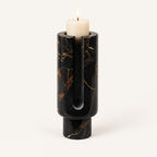 Eclipse candle holder in Obsidian Black marble with gold veining and a lit pillar candle
