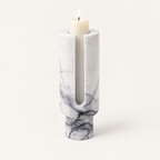 Eclipse candle holder in Arctic White marble with a lit pillar candle