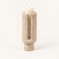 Eclipse candle holder in Travertine Beige stone with a lit pillar candle