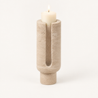 Eclipse candle holder in Travertine Beige stone with a lit pillar candle